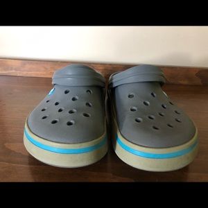 Grey Crocs with blue croc band.